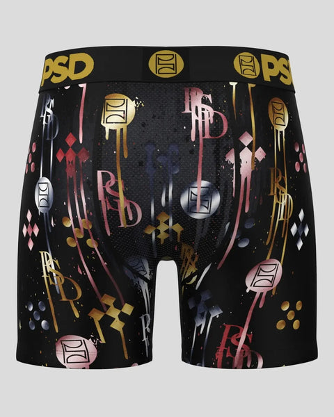 Black boxer briefs with gold, pink, and navy graphic print pattern and gold PSD waistband.