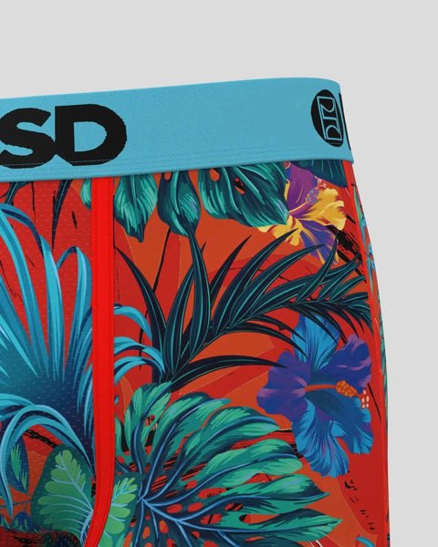 Red swim briefs with tropical floral print in blue, green, and yellow, featuring turquoise waistband with brand logo.