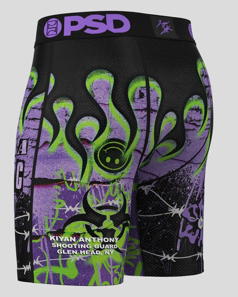 Black PSD shorts with neon green and purple octopus design, purple waistband, and text reading 