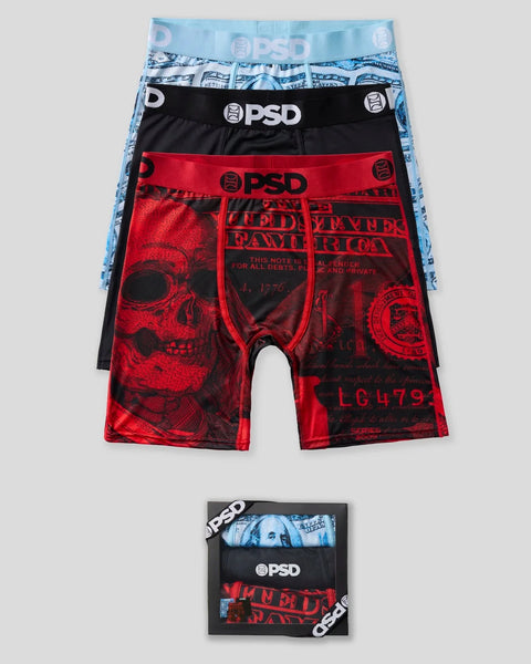 Three PSD boxer briefs in light blue with pattern, black solid, and red with skull design, displayed stacked with product pac