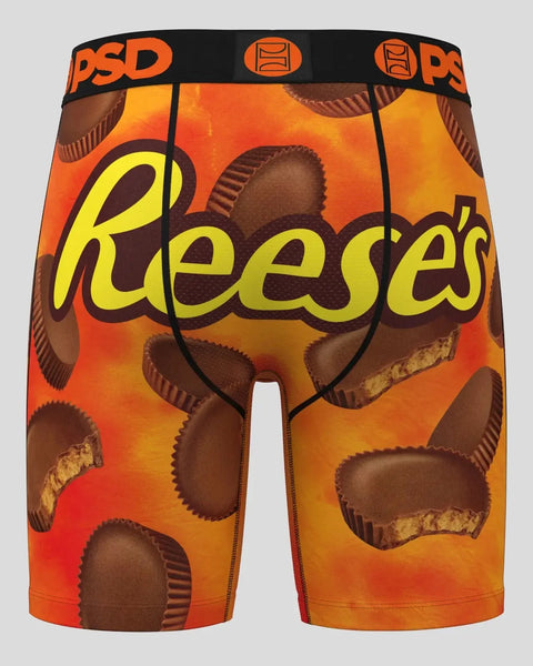 PSD underwear shorts with Reese's peanut butter cup print on orange and brown background.