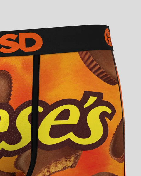 Reese's candy package showing chocolate peanut butter cups with orange and brown branding and black waistband.