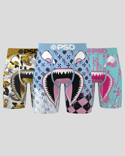 Three PSD boxer briefs in gold, blue, and teal with monster mouth graphic designs and PSD waistbands.