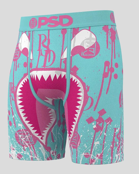 PSD turquoise boxer shorts with magenta shark mouth graphic and text print throughout.