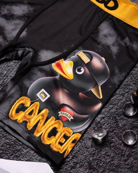 Black backpack with printed black duck, yellow text, gold accents, and shoulder straps.