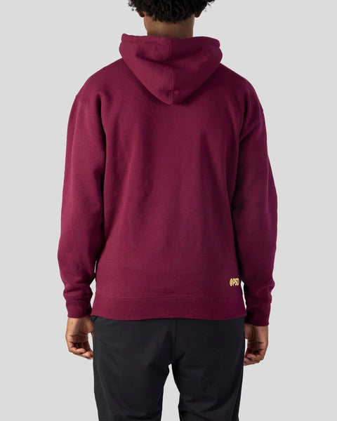 Maroon pullover hoodie with drawstring hood, shown from back view on model wearing black pants.