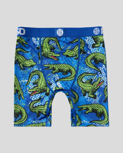 Blue boxer briefs with all-over green alligator print, red mouths, and white dot details, featuring blue waistband with logo.