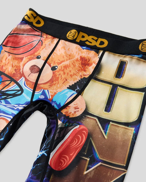 PSD brand underwear with orange teddy bear design and basketball graphic, black waistband with gold logo.