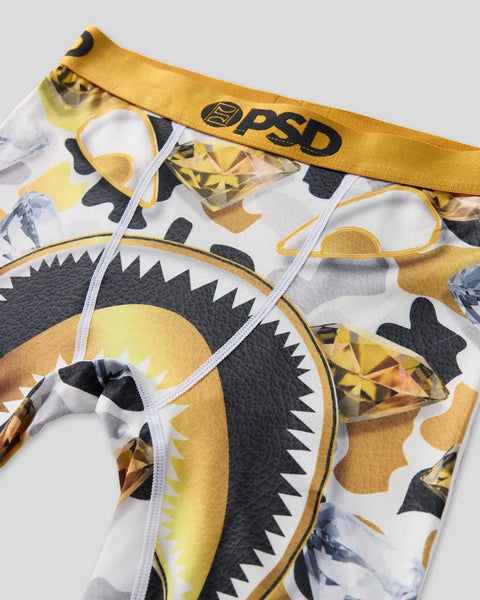 PSD underwear with gold waistband and graphic print featuring yellow and black monster faces.