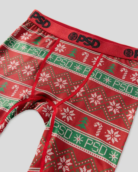 Red and green knit sweater with white and gold snowflake and geometric Fair Isle pattern, PSD branding on waistband.