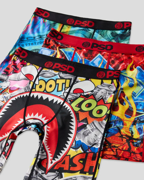 Three PSD brand underwear with red waistbands in assorted colorful prints including comic book graphics and dollar bill patte
