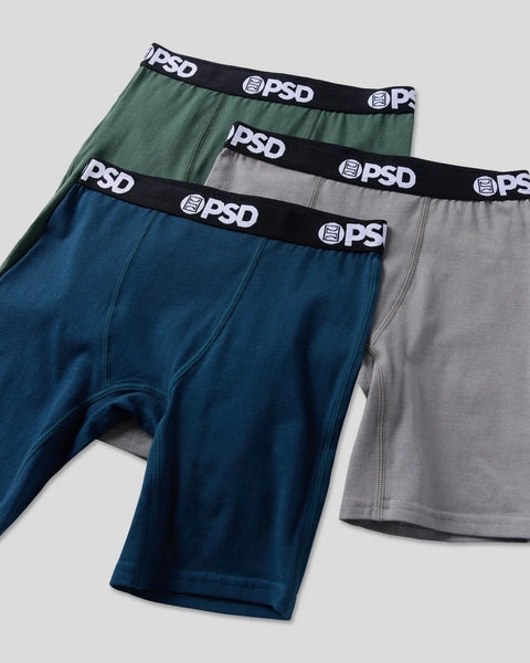 Three PSD boxer briefs in navy blue, gray, and sage green with black waistbands.