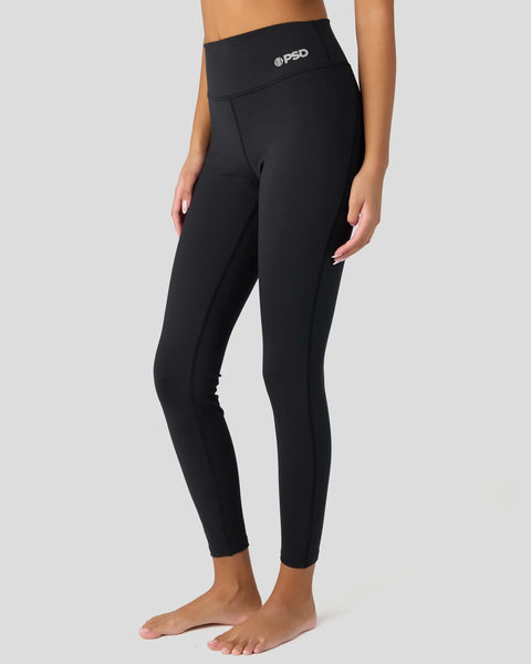 Black high-waisted leggings with @PSD branding on the waistband, shown on model from waist to feet.