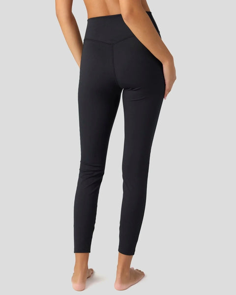 Black high-waisted leggings with a side pocket, shown from the back on a model.