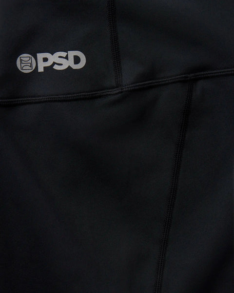 Black PSD athletic garment with gray logo and center seam detail.