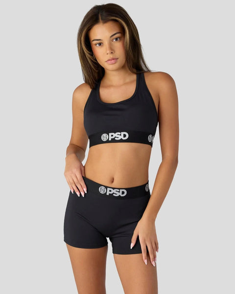 Black sports bra and shorts set with PSD branding on elastic bands.