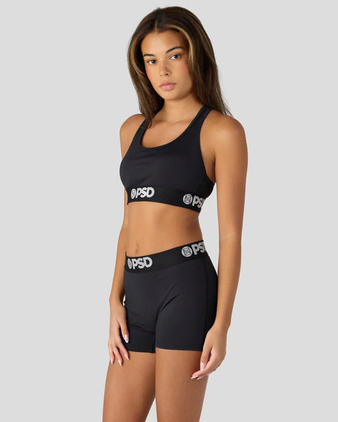 Black sports bra and shorts set with branded waistband details.