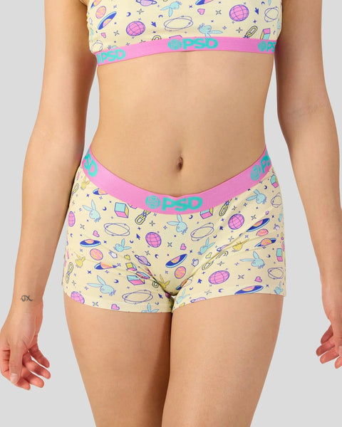 Cream bralette and boyshort set with space icons and pink/turquoise elastic bands.