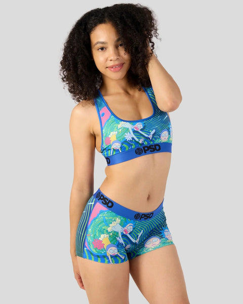 Colorful sports bra and shorts set with Rick and Morty characters and blue waistband on model with curly hair.