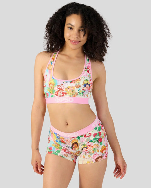 Pink sports bra and shorts set with colorful cartoon character and fruit print throughout.