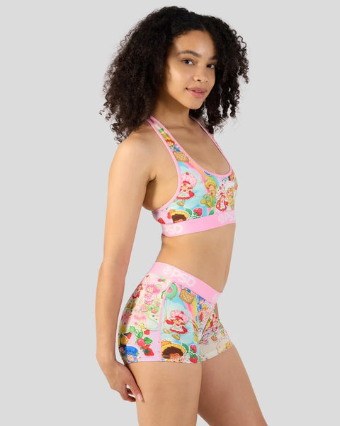 Halter crop top and shorts set with colorful Strawberry Shortcake character print on pink and mint background.