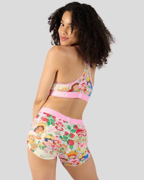Pink two-piece set with cartoon character and strawberry print, featuring halter crop top and shorts.