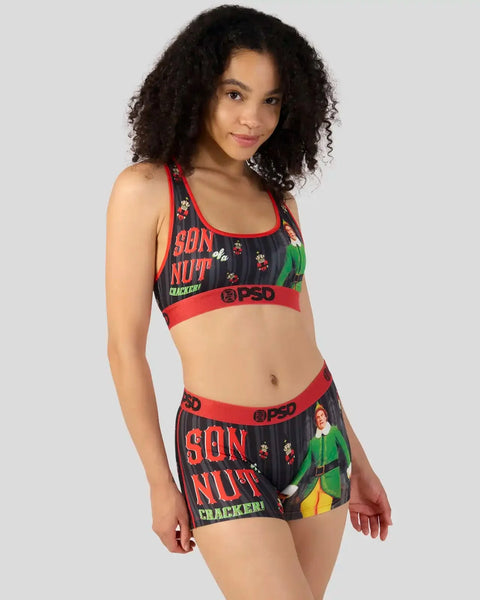 Woman wearing black sports bra and shorts with red trim and 
