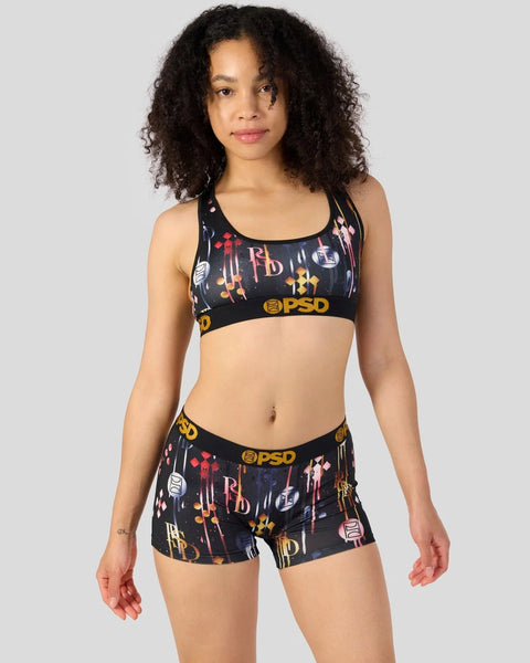 Black sports bra and shorts set with multicolored abstract print and PSD branding.
