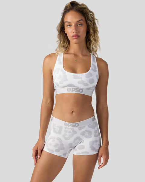 White sports bra and shorts set with gray leopard print pattern and branded waistband.