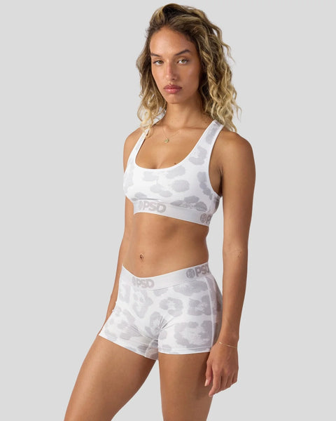 White and gray camouflage sports bra and shorts set with branded waistband on model.