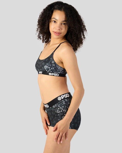 Black patterned sports bra and matching shorts with PSD branded elastic waistbands.