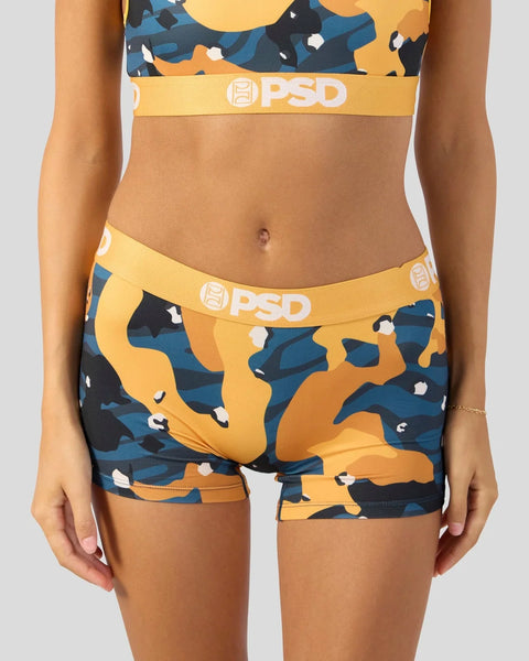 PSD sports bra and boyshort set in yellow, navy, and orange camouflage pattern with white logo waistband.