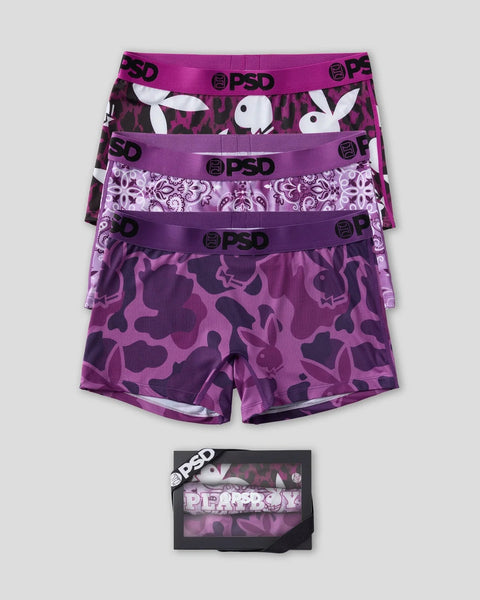 Three purple PSD boxer briefs with Playboy bunny logo prints and patterned designs, displayed stacked with packaging.