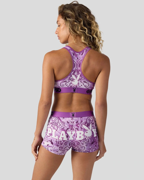 Purple racerback sports bra and shorts set with ornate damask print and text logo.