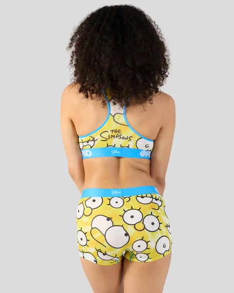 Yellow and blue two-piece swimsuit set with cartoon eyes pattern and The Simpsons branding.