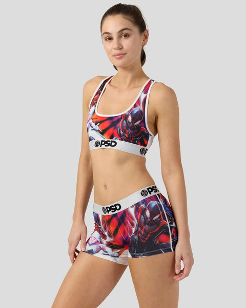 Woman wearing red and black Spider-Man print sports bra and shorts set with white trim and PSD branding.