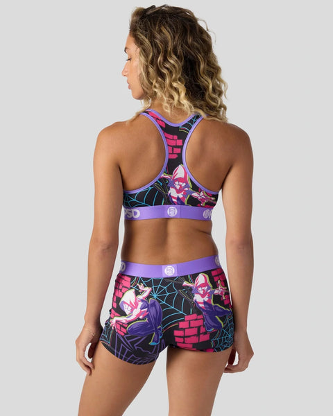 Woman wearing Ghost-Spider-themed sports bra and shorts with purple trim, pink and black graphic print, and web pattern desig