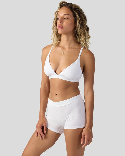 White wrap-front bikini top and matching shorts on model against neutral background.