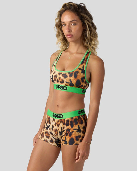 Leopard print sports bra and shorts set with neon green trim and branding.