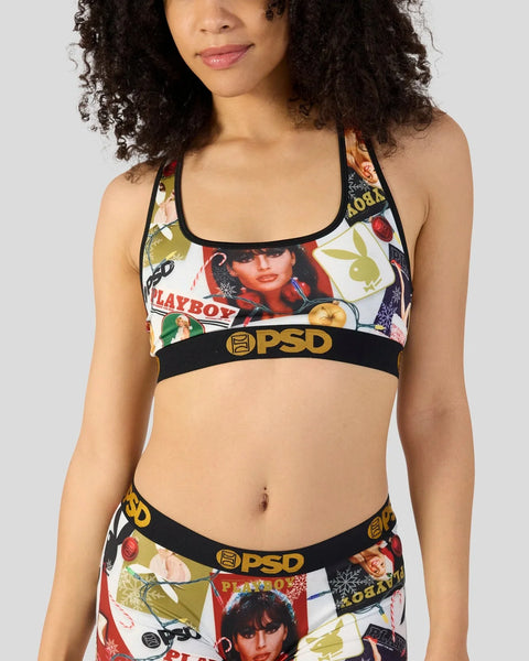 Woman wearing PSD sports bra and underwear set with Playboy Christmas-themed print and black trim.