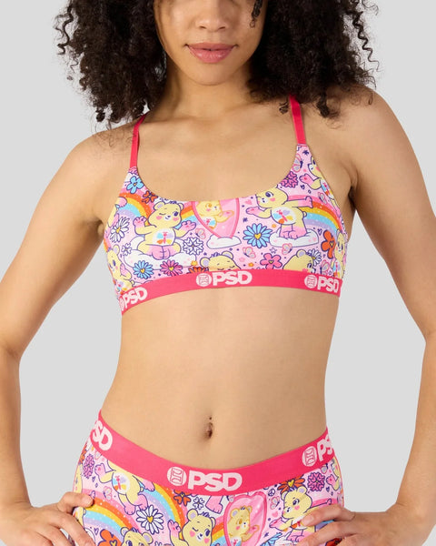 Care Bears Self-Care Bear print sports bra with pink straps and PSD waistband on model.