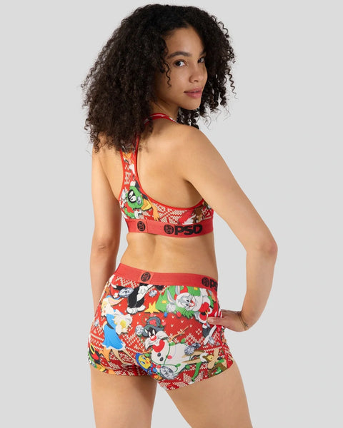 Woman wearing red Looney Tunes-themed bra and shorts set with cartoon character prints and red waistband with PSD branding.