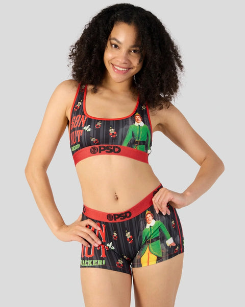 Woman wearing black and red PSD sports bra and shorts with elf character print and red elastic waistbands.