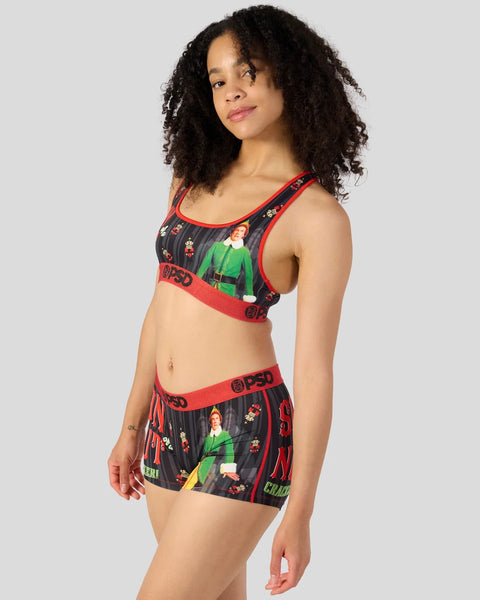 Women's sports bra and shorts set with elf character print, red trim, and branded waistband.