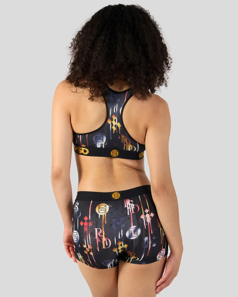 Black sports bra and shorts set with multicolored geometric and text graphic print throughout.