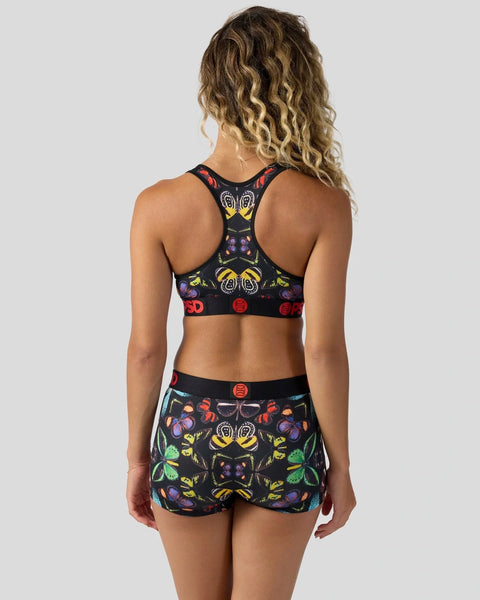 Black sports bra and shorts set with colorful embroidered butterfly and floral pattern, shown from back.