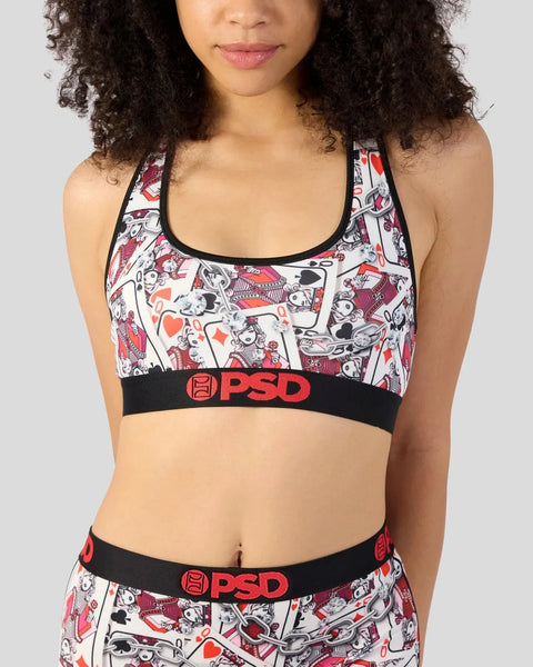 Woman wearing white, red and black cartoon-print sports bra with black PSD waistband and matching bottoms.