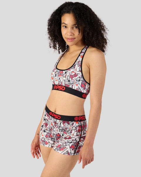 Woman wearing a comic-print sports bra and matching shorts set with black elastic bands and red logo details.