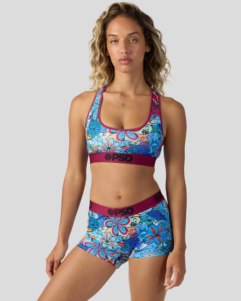 Colorful floral print sports bra and matching shorts set with burgundy trim and logo waistband.