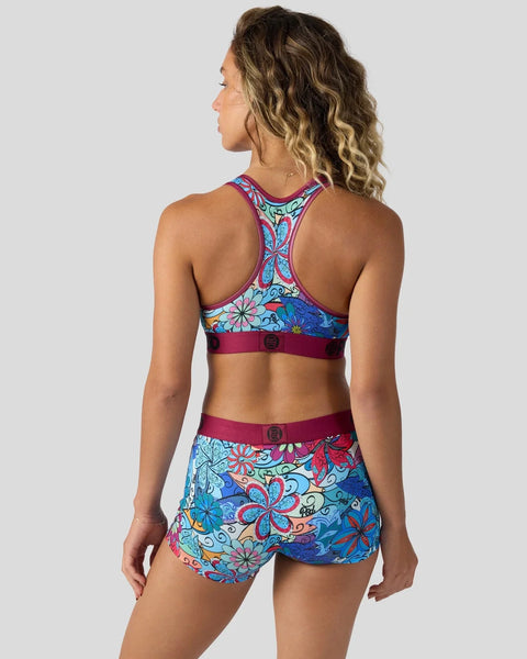 Women's sports bra and shorts set with colorful floral paisley print and burgundy trim.